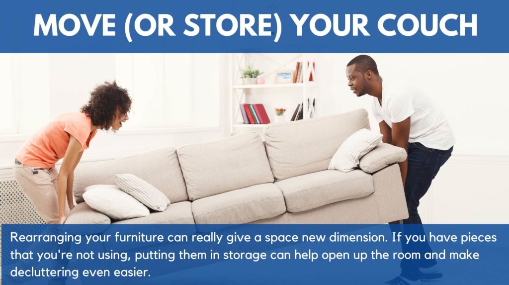 A couple moving a sofa around their house or apartment. This shows how rearranging furniture can really change the look of a space or room.