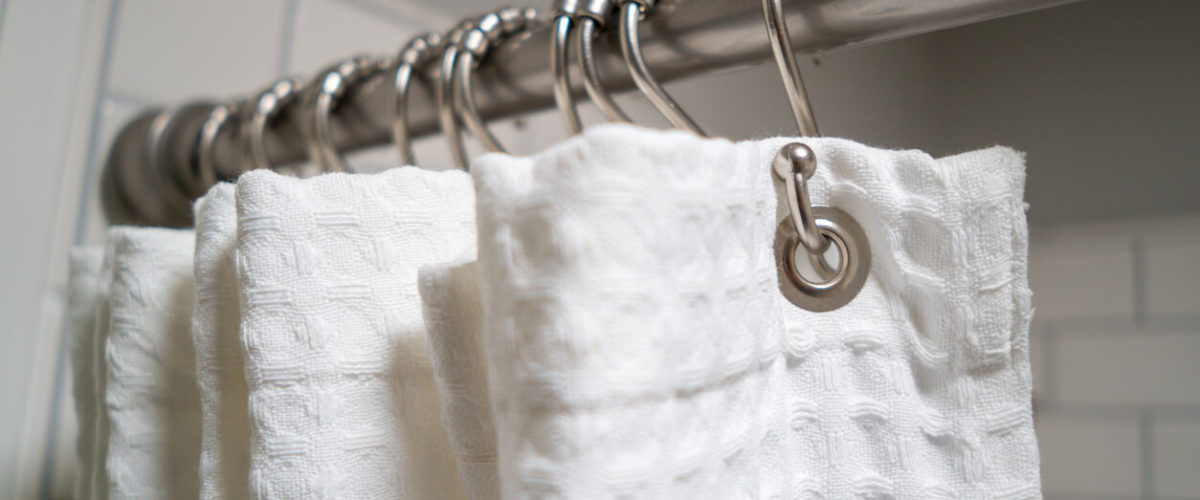 white shower curtain on rings