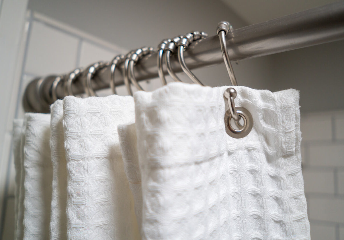 white shower curtain on rings