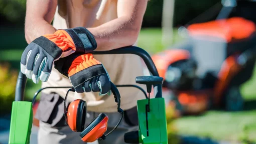 landscaper leaning on lawnmower