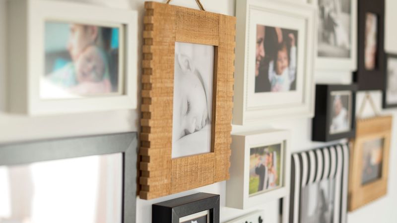 a wall overfilled with family photos