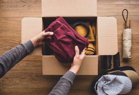 folded sweatshirts being placed into a box