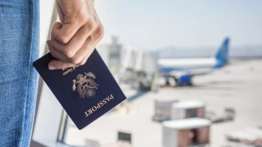 woman holding a passport, waiting at the airport for a flight