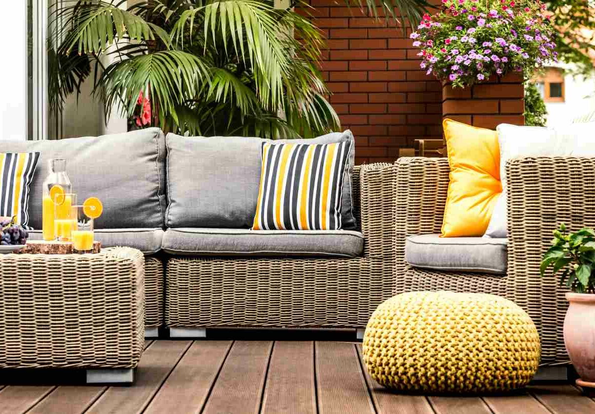 Wicker patio furniture sits on a deck