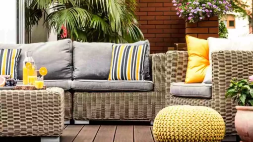 Wicker patio furniture sits on a deck