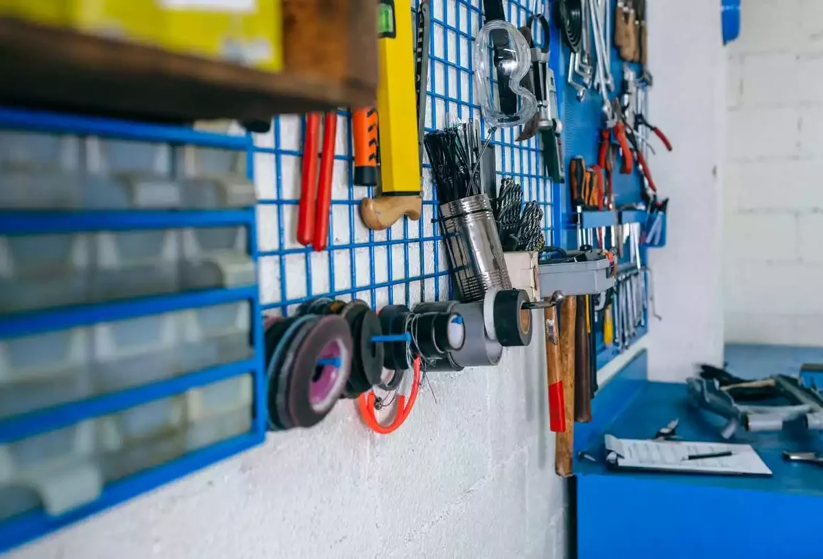 Tools hand on an organizer in a garage.