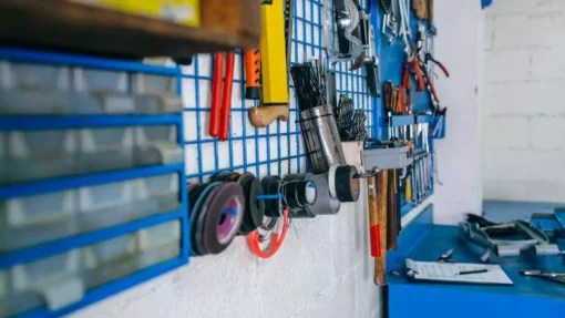 Tools hand on an organizer in a garage.