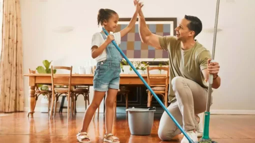 A father and his young daughter work together during spring cleaning.