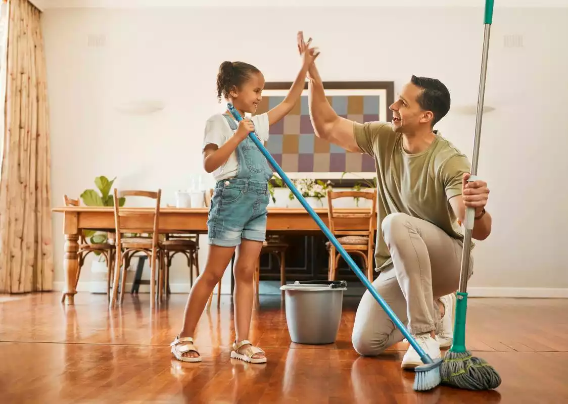 A father and his young daughter work together during spring cleaning.