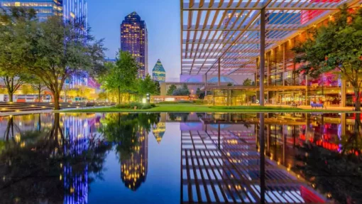 A view of the downtown cityscape of Dallas, TX, at twilight.