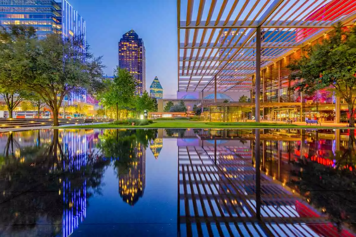 A view of the downtown cityscape of Dallas, TX, at twilight.