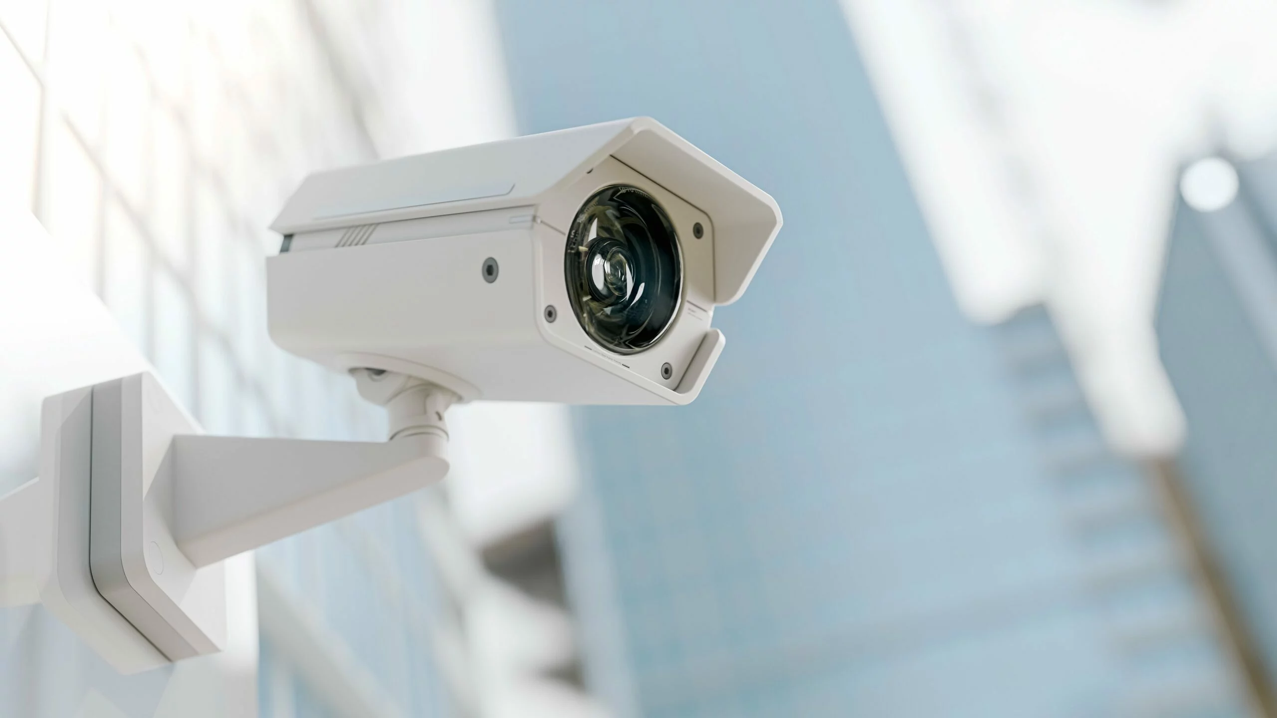 A security camera mounted on the wall of a building.