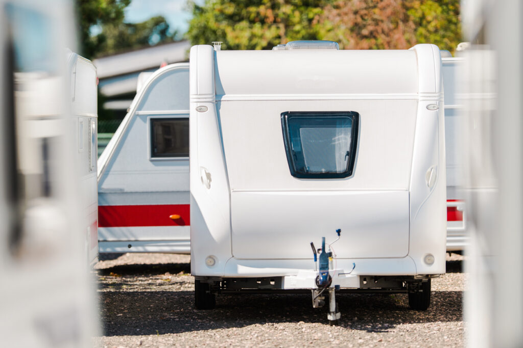 An RV trailer parked in outdoor RV camper storage.