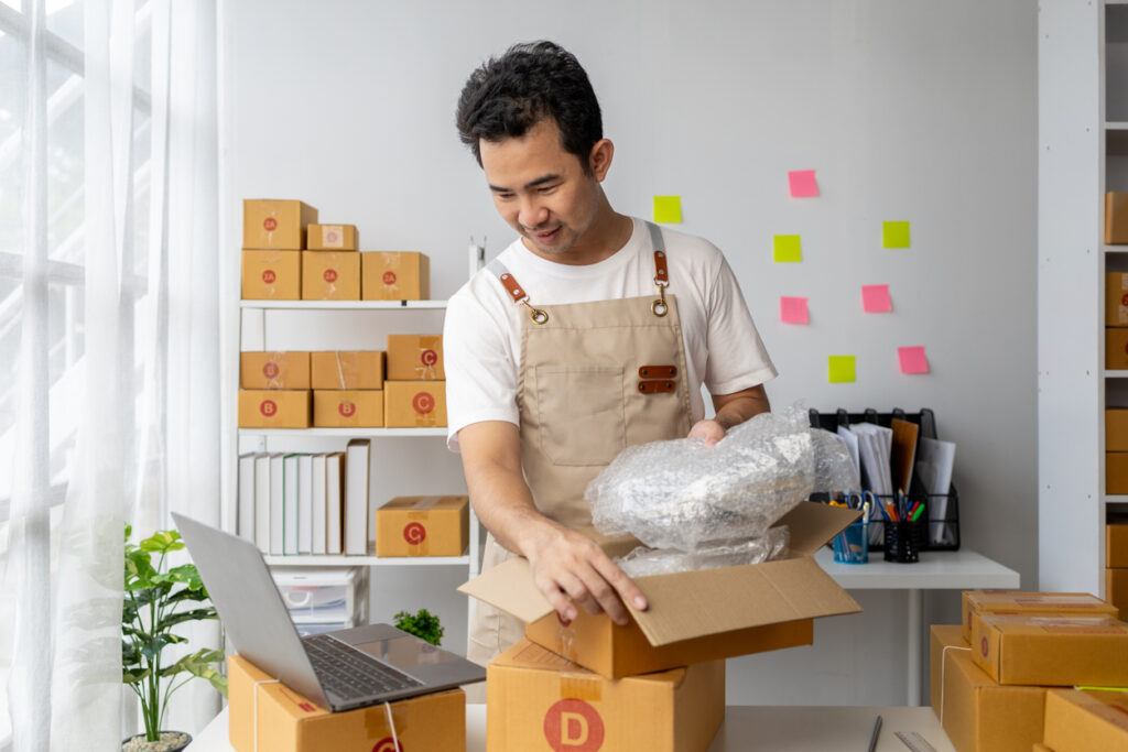 An online business owner packing and labeling boxes.