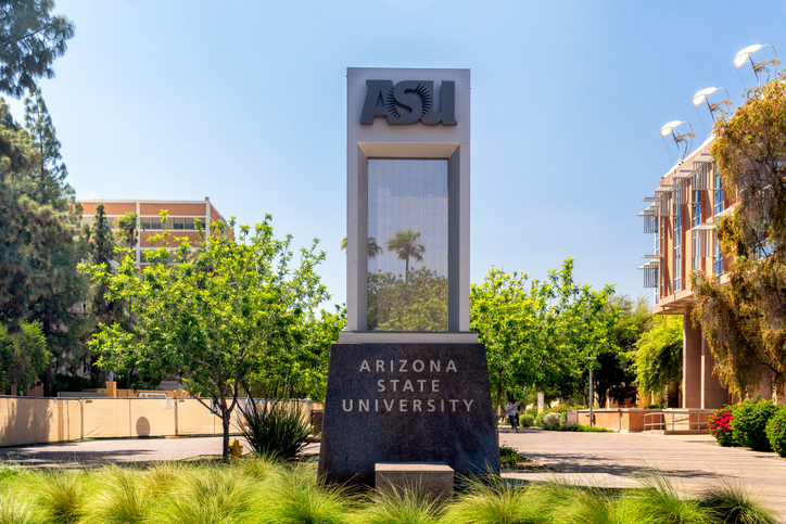 A large, rectangular, stone statue outside of Arizona State University that says “Arizona State University.”