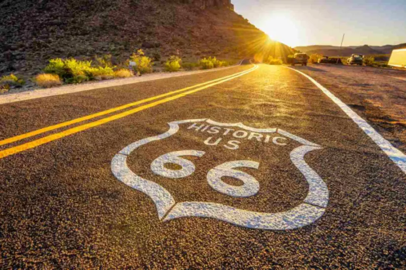 A painted street sign marking historic Route 66 in the Mojave Desert.