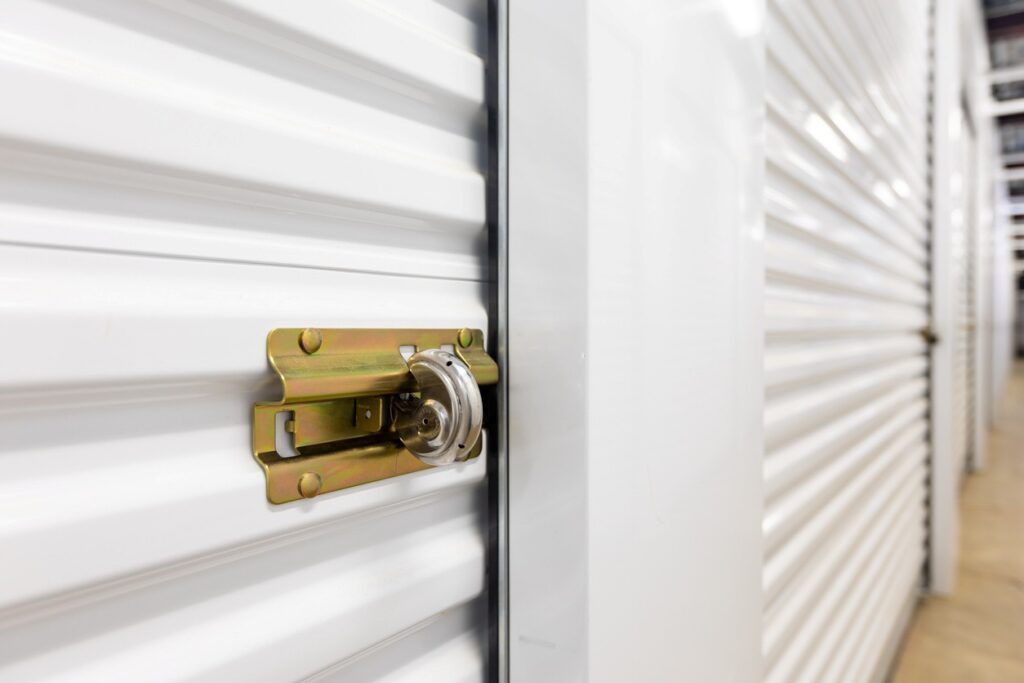 A close-up of a sleek metallic padlock on a concrete floor, symbolizing secure storage managed through mobile app tools.